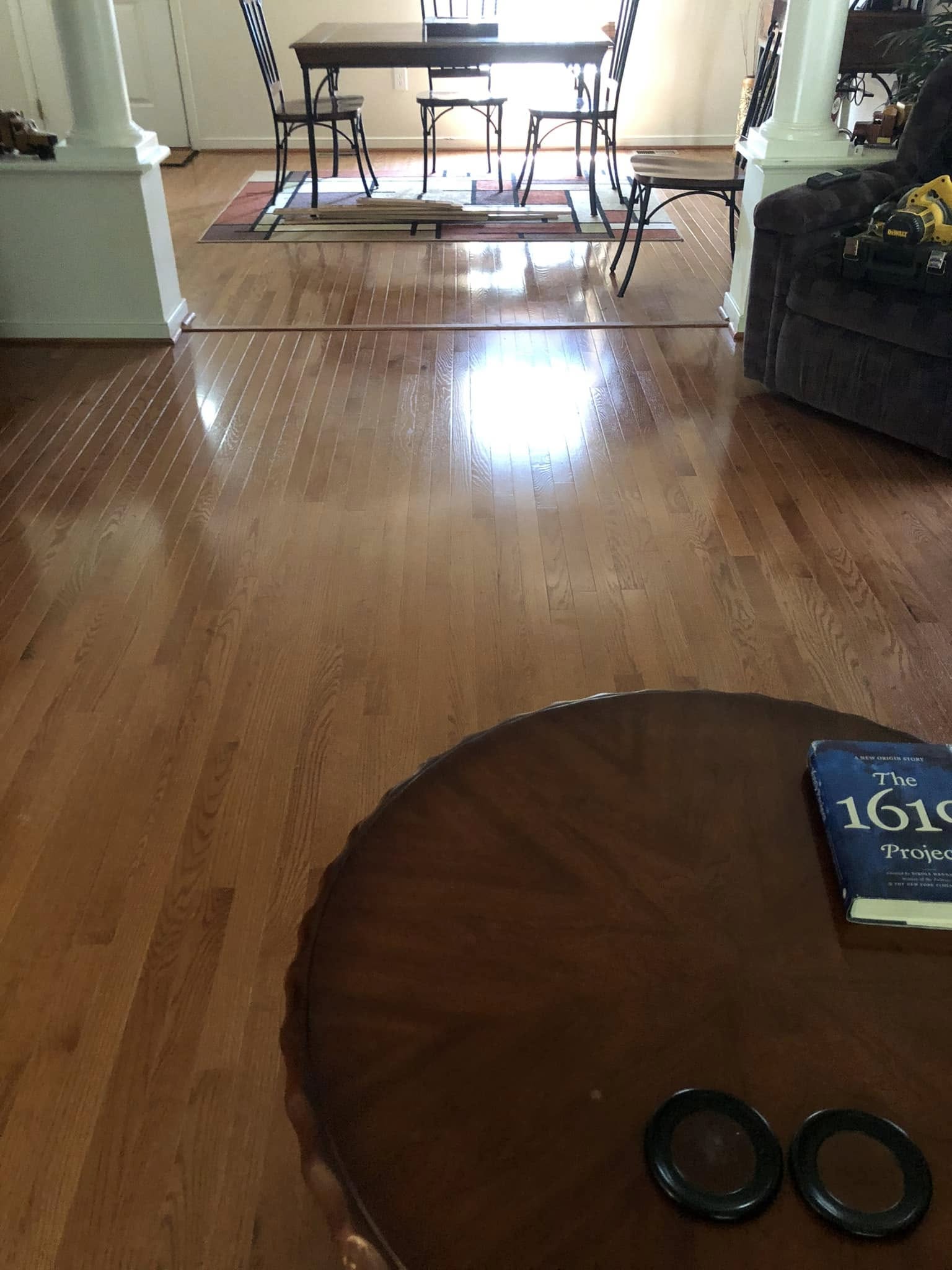 Freshly finished red oak hardwood floor running through an open living and dining area